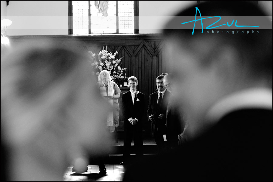 Ben waits for his beautiful bride Lauren. Downtown Raleigh wedding photogaph of bride walking down aisle.