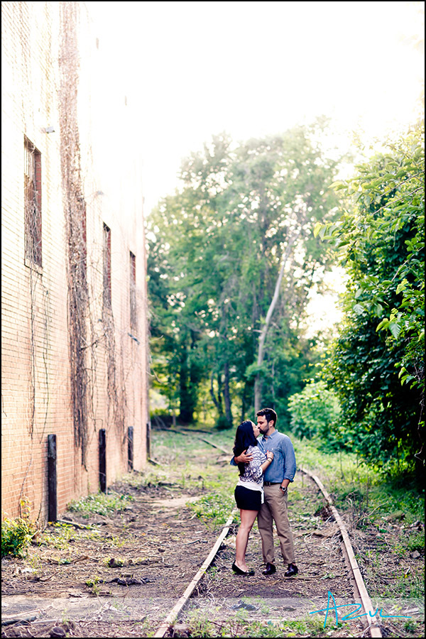 A kiss on the tracks Urban engagement portrait session NC