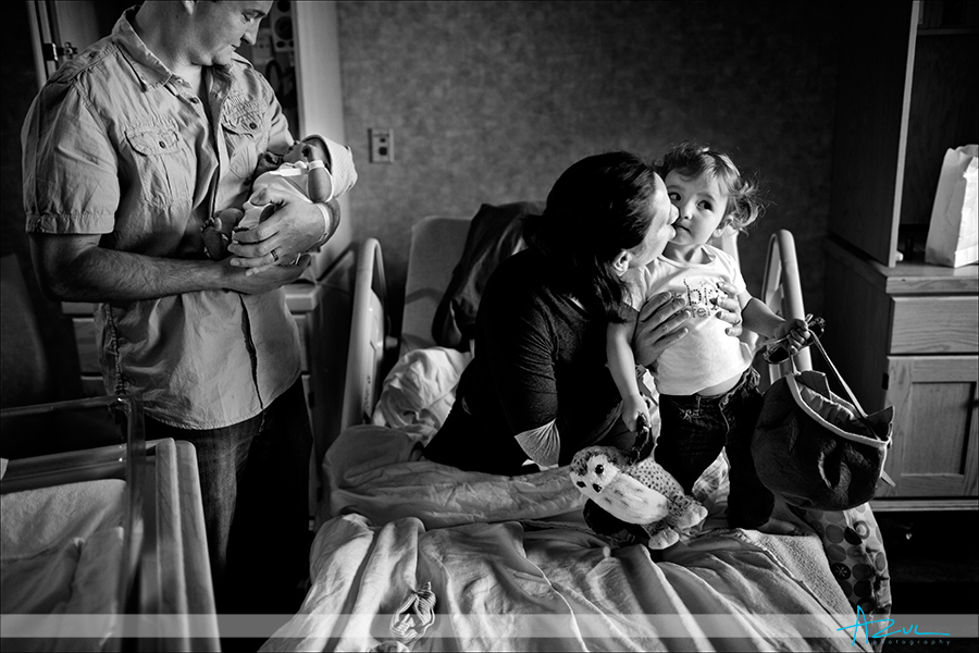 A kiss for Jori as JJ holds Liam Creative baby portrait photographer Raleigh